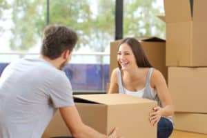 Man and woman packing a packing moving boxes