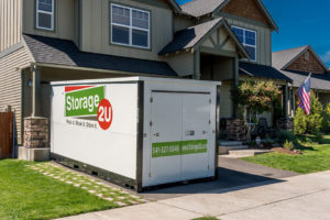 A Storage 2U branded storage container in front of a residential house